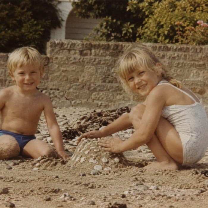 Two small children building a sandcastle in the nineteen eighties